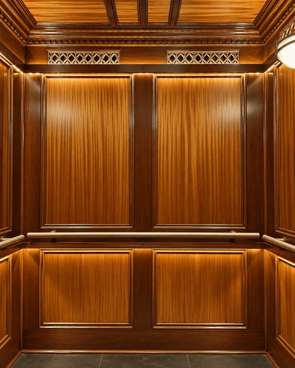 Luxurious wooden elevator with warm lighting and detailed paneling.
